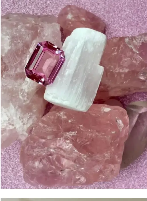 Pink gemstone and selenite resting on rose quartz